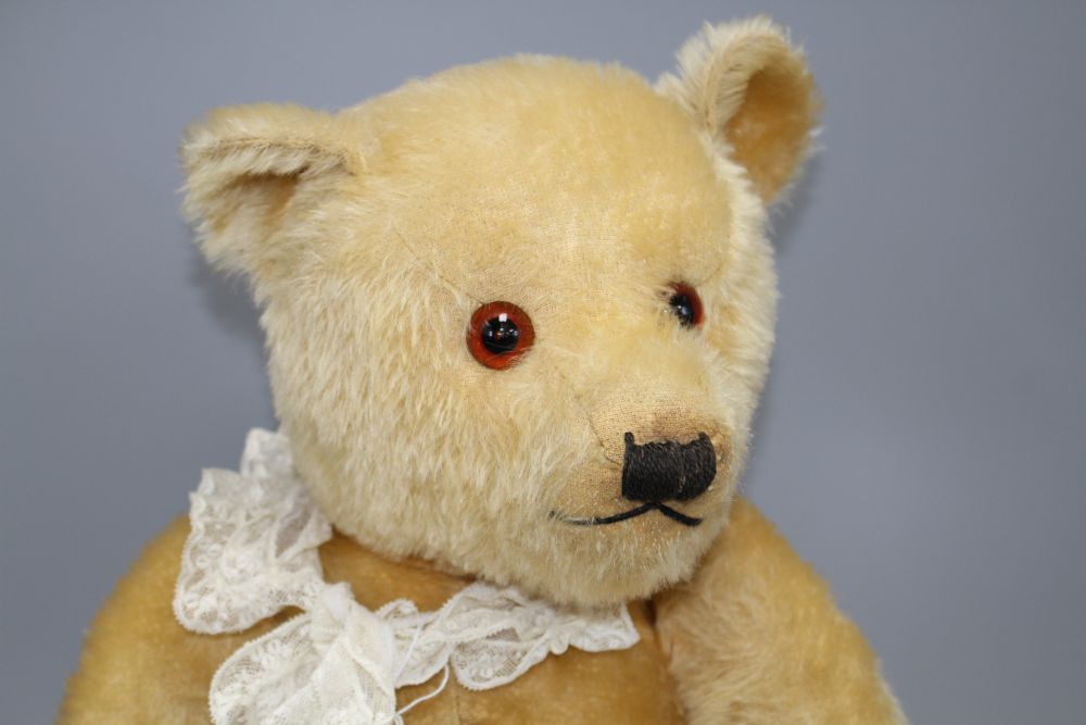 A Chiltern type bear, blond mohair, glass eyes, original pads, some slight staining on centre seam otherwise good condition
